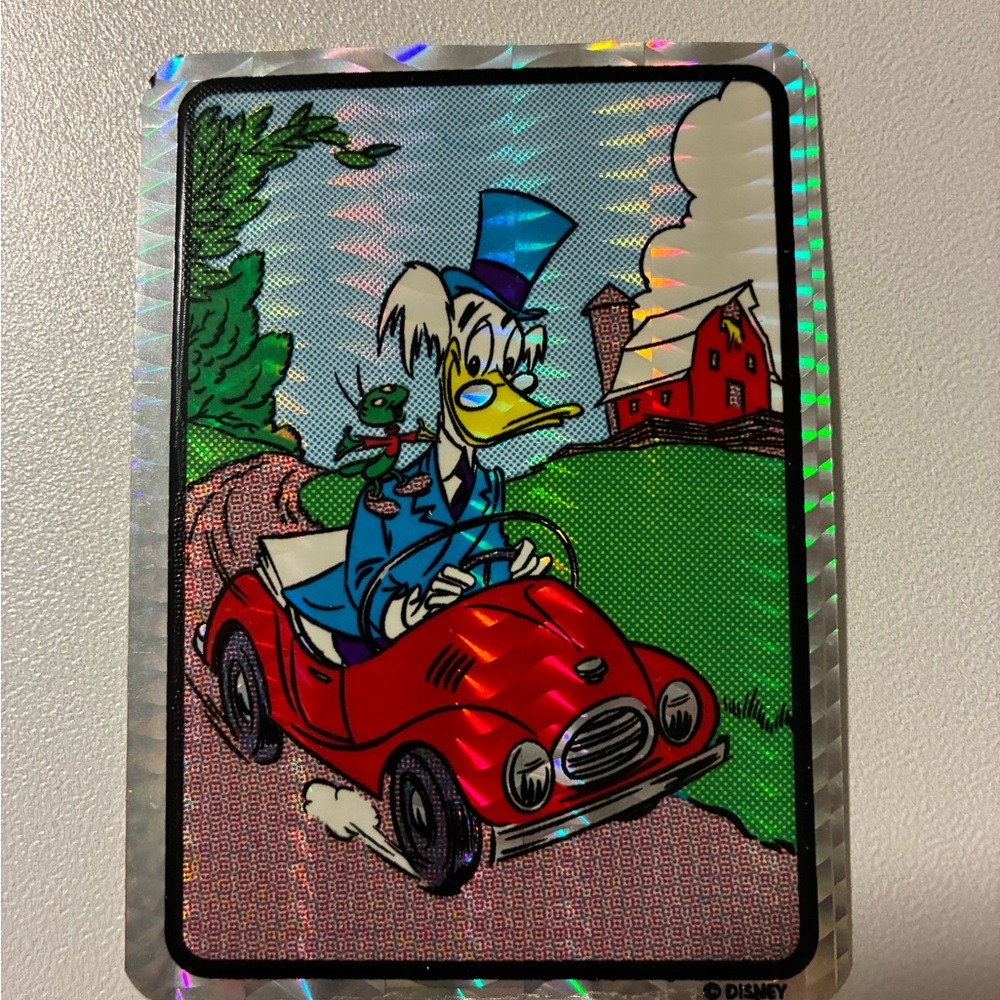 Disney Holographic Sticker — Red Car, Blue Outfit, Green Background